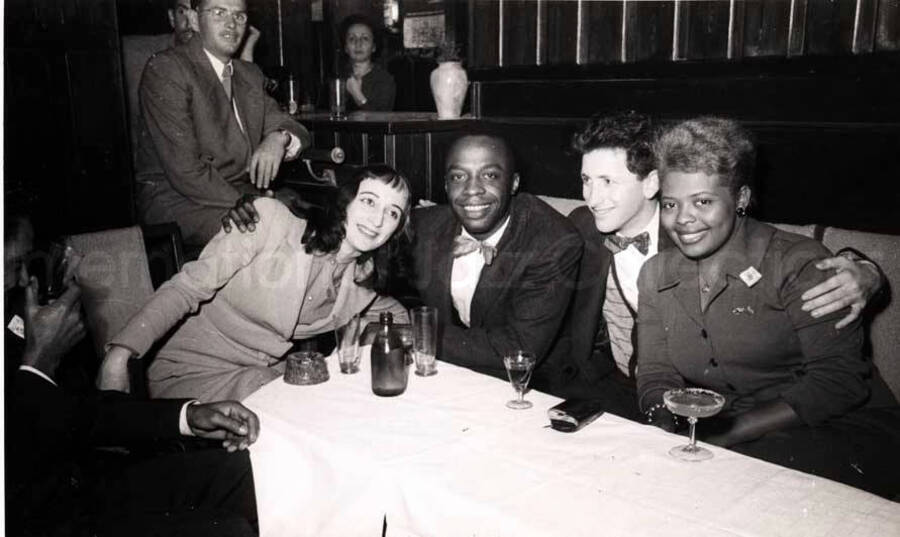5 x 8 inch photograph. Members of the Lionel Hampton's band with unidentified persons in a restaurant in Israel