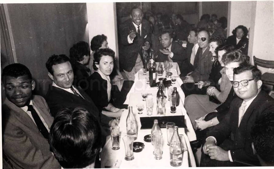 5 x 8 inch photograph. Lionel Hampton with unidentified persons in a restaurant in Israel. Seen on the left is Leo Moore