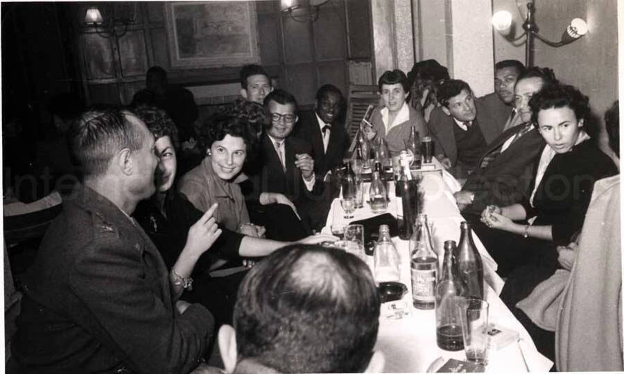 5 x 8 inch photograph. Members of the Lionel Hampton's band with unidentified persons in a restaurant in Israel