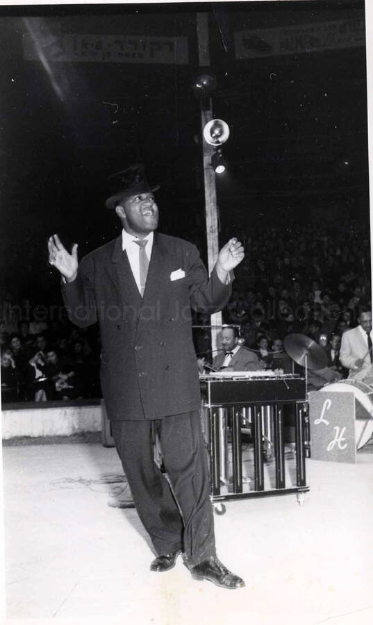 5 x 8 inch photograph. Lionel Hampton performing with band in Israel. Unidentified man