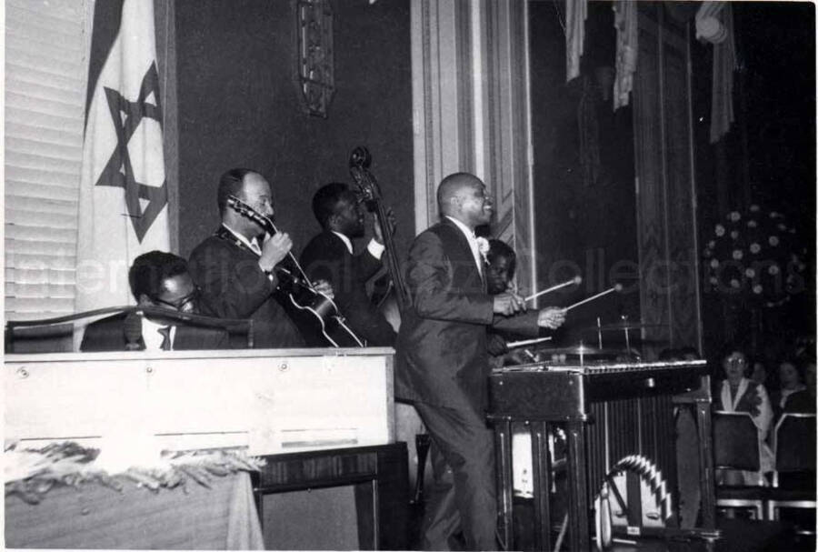 4 x 5 1/2 inch photograph. Lionel Hampton on vibraphone with band, which includes guitarist Billy Mackel, at the Youth Aliyah conference, Israel