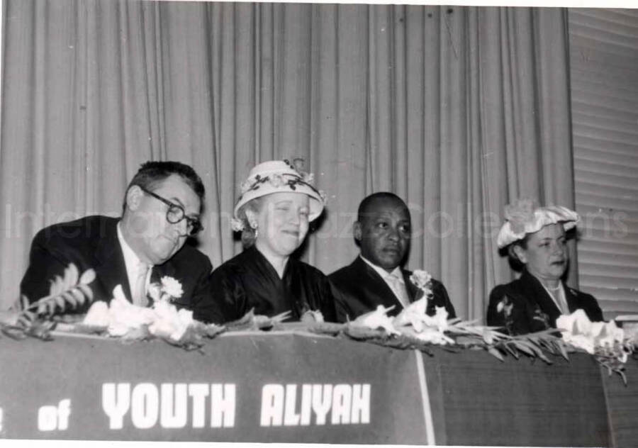 4 x 5 1/2 inch photograph. Lionel Hampton with unidentified persons, at the Youth Aliyah conference, Israel