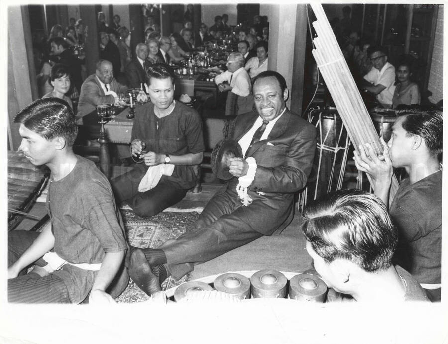 8 x 10 inch photograph. Lionel Hampton with unidentified musicians. Billy Mackel is among the audience