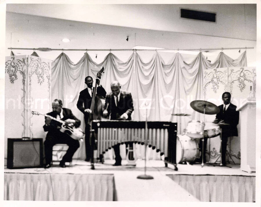 8 x 10 inch photograph. Lionel Hampton on vibraphone with two unidentified musicians and guitarist Billy Mackel