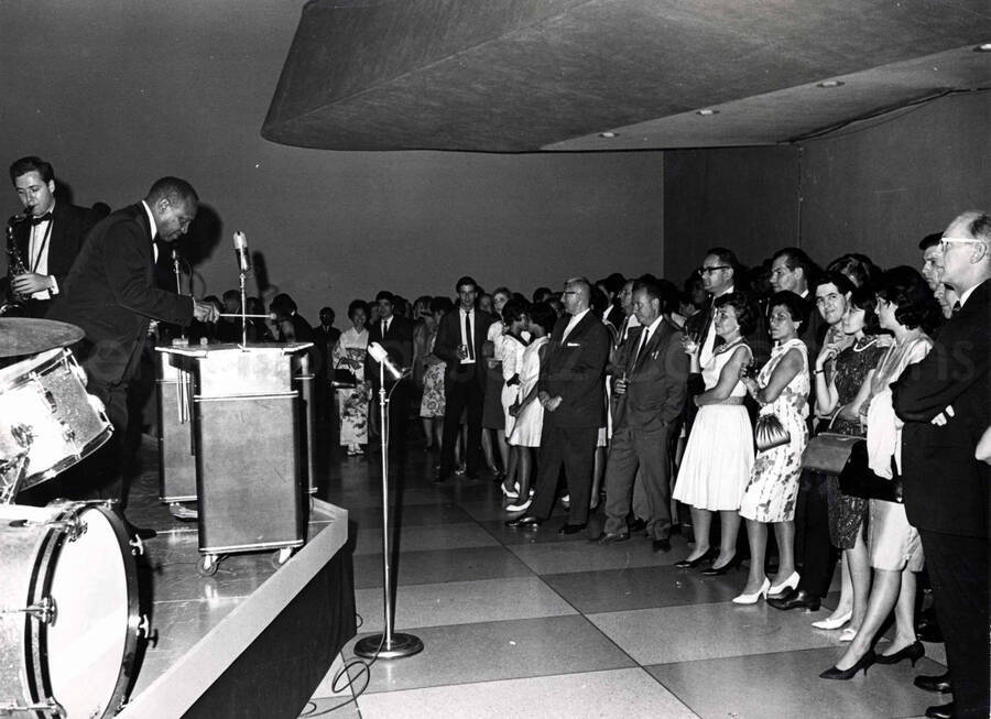 7 x 9 inch photograph. Lionel Hampton on vibraphone with audience, including a woman dressed in Japanese costume
