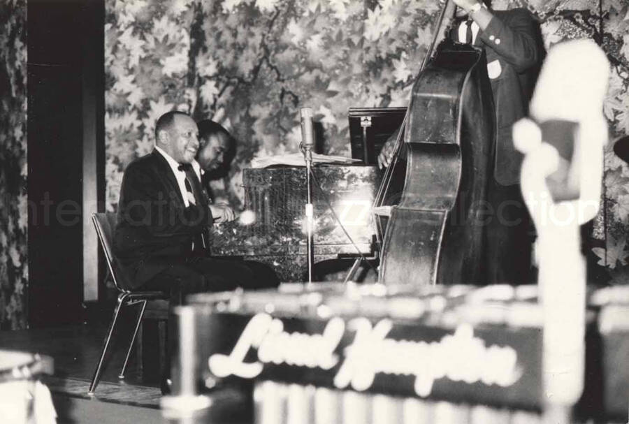3 x 4 1/2 inch photograph. Lionel Hampton playing the piano with band, in Osaka, Japan
