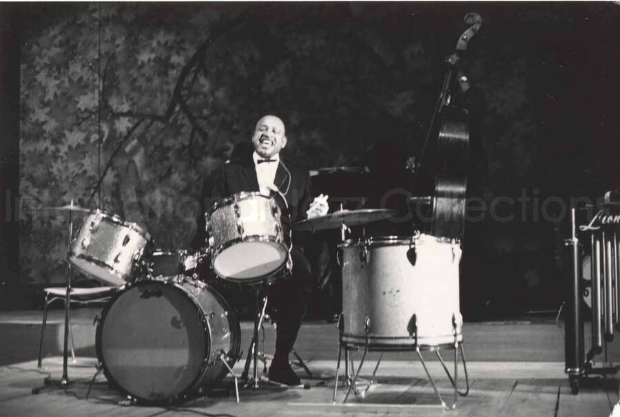 3 x 4 1/2 inch photograph. Lionel Hampton playing the drums with band, in Osaka, Japan