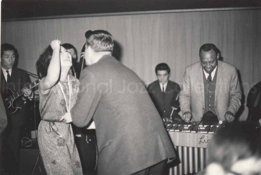 3 x 4 1/2 inch photograph. Lionel Hampton playing the vibraphone with band, in Osaka, Japan