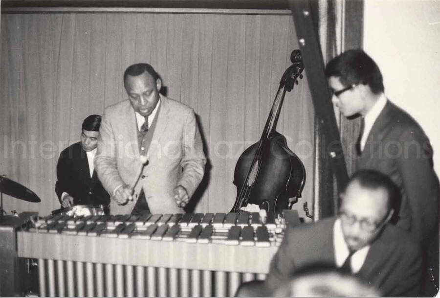 3 x 4 1/2 inch photograph. Lionel Hampton playing the vibraphone with band, in Osaka, Japan
