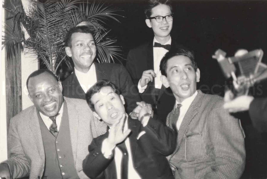 3 x 4 1/2 inch photograph. Lionel Hampton and Leo Moore with unidentified men in Osaka, Japan