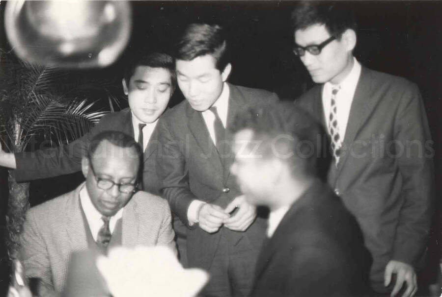 3 x 4 1/2 inch photograph. Lionel Hampton with unidentified men in Osaka, Japan