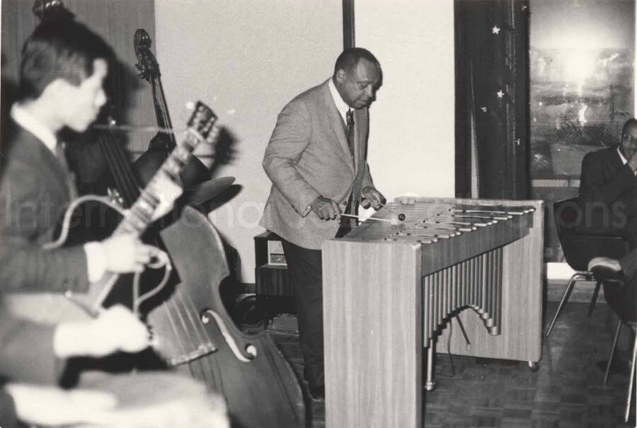 3 x 4 1/2 inch photograph. Lionel Hampton playing the vibraphone with band, in Osaka, Japan