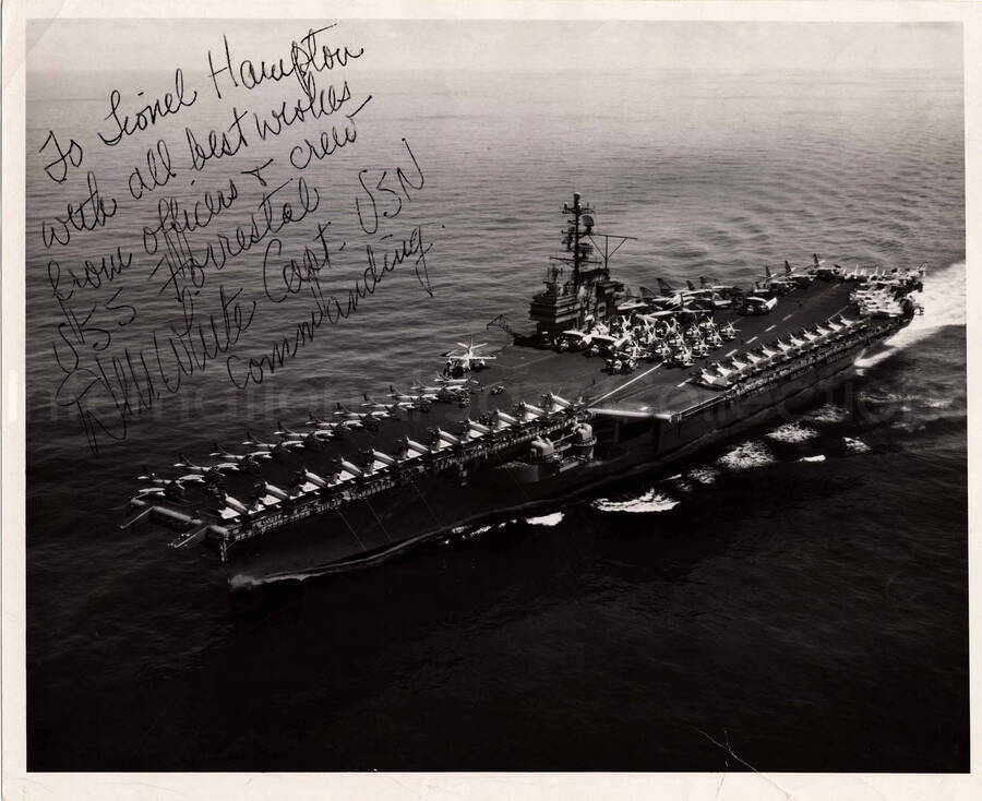 8 x 10 inch photograph. Aircraft carrier. Inscription on the back of the photograph:  File n. CVA-59-19745-L-8-61; USS Forrestal CVA-59, enroute conus after 1961 Mediterranean deployment. This photograph is dedicated to Lionel Hampton