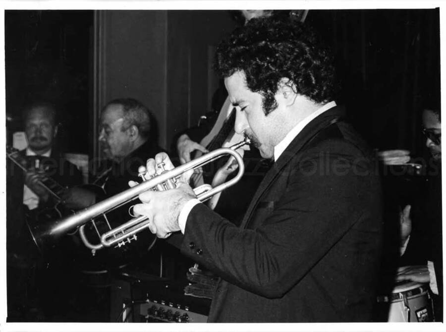 5 x 7 inch photograph. Unidentified trumpeter with guitarist Billy Mackel in the background