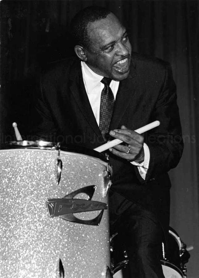 9 x 6 3/4 inch photograph. Lionel Hampton playing Trixon drums [in Germany]