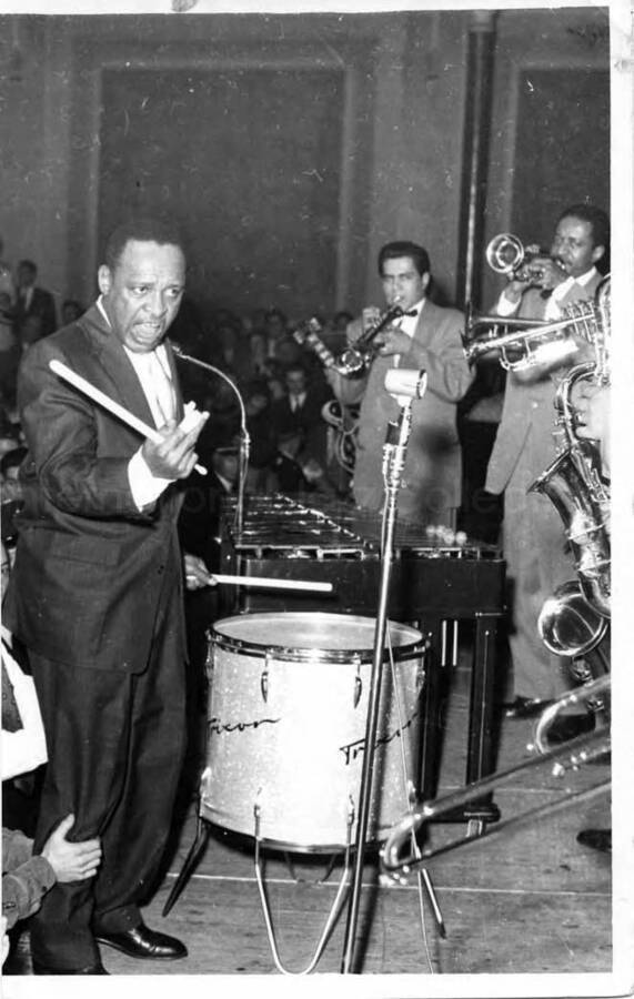 7 x 4 1/2 inch photograph. Lionel Hampton playing Trixon drums