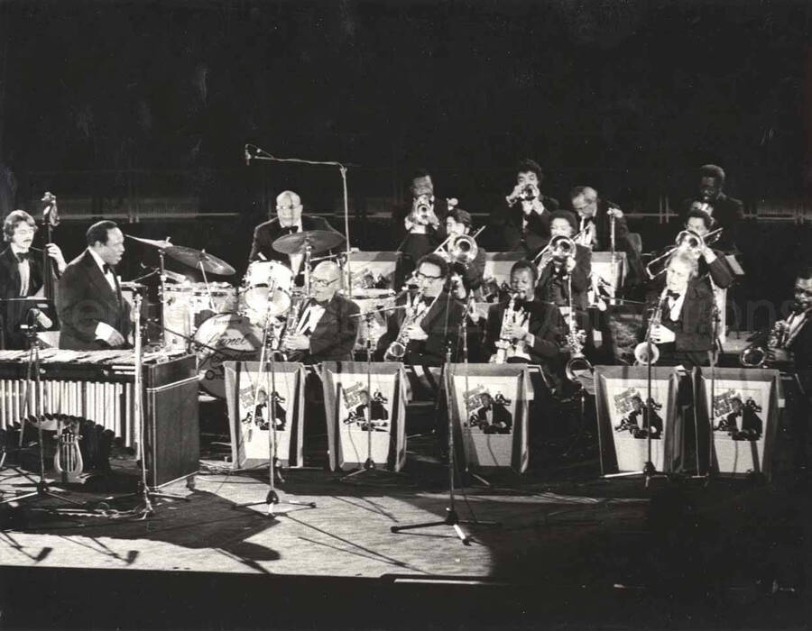6 1/2 x 8 1/2 inch photograph. Lionel Hampton with band in Germany. Printed on the back of the photograph: Berliner Jazztage 1979; Lionel Hampton All Star Big Band, Regie: Oskar Kruger; Sender Freies Berlin, Feb. 1980