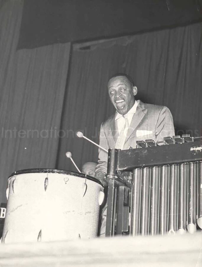 9 1/2 x 7 inch photograph. Lionel Hampton playing Trixon drums with unidentified pianist and guitarist Billy Mackel. [Milan, Italy?]
