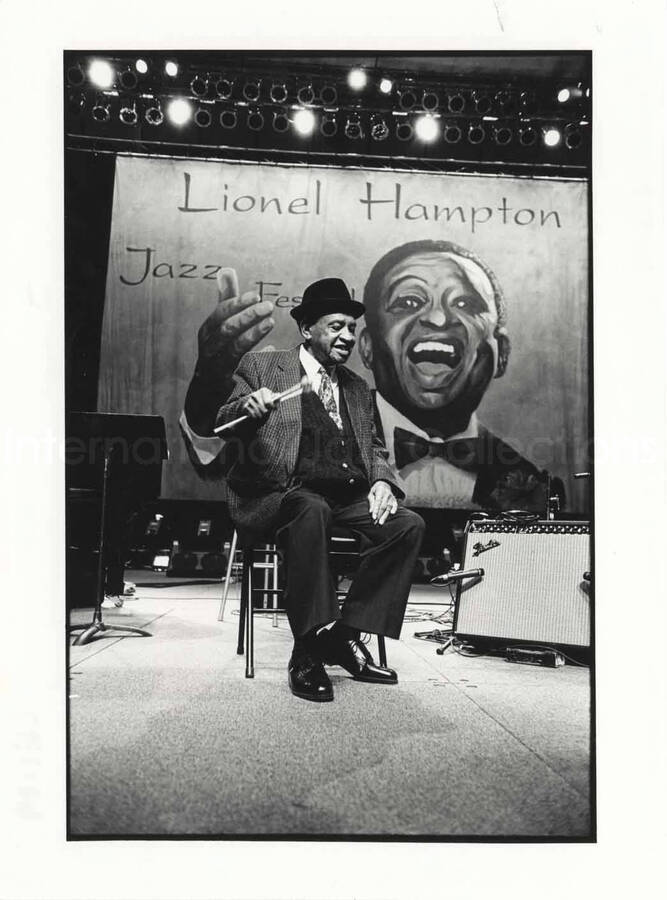 9 1/2 x 7 inch photograph. Lionel Hampton on stage. A banner on the background reads: Lionel Hampton Jazz Festival. [Paris, France?]