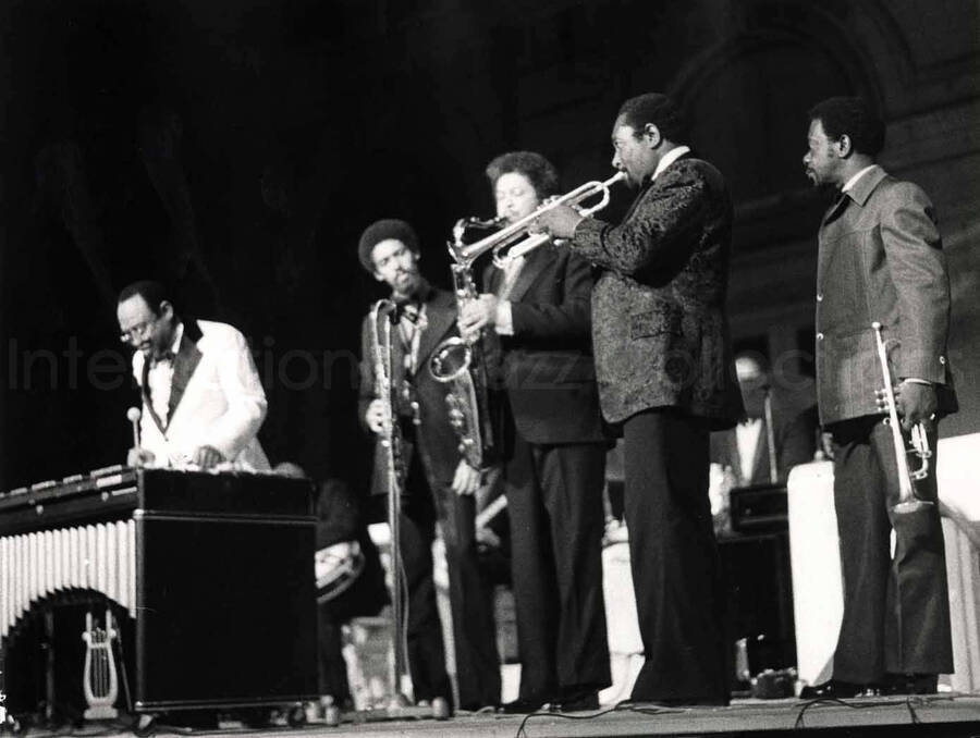 7 x 9 1/2 inch photograph. Lionel Hampton performing on vibraphone accompanied by unidentified musicians. [Marseille, France?]