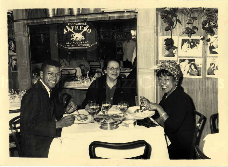 5 x 7 inch photograph. Gladys Hampton  with Leo Moore and an unidentified woman at the restaurant Alfredo, in Rome, Italy