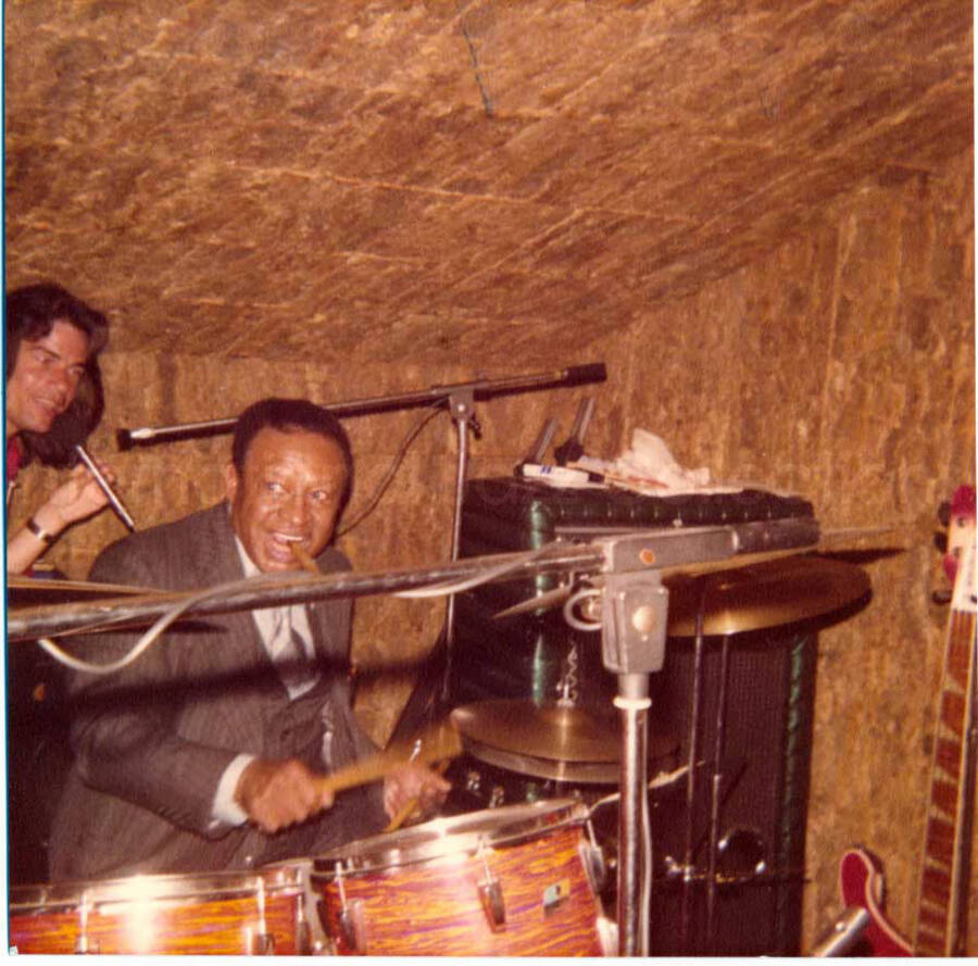 3 1/2 x 3 1/2 inch photograph. Lionel Hampton playing the drums [in Lucerne, Switzerland?]. Handwritten on the back of the photograph: Luzern