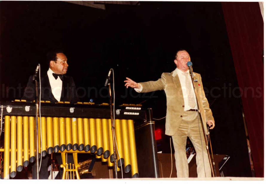 4 x 6 photograph. Lionel Hampton playing the vibraphone. Stamped on the back of the photograph: U.S.A. Jazz Sessions Club, Antwerp, Belgium. Handwritten on the back of the photograph: It Don't Mean a Thing; Lionel and Big Joe