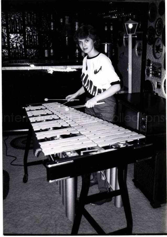 5 x 3 1/2 inch photograph. A young woman playing the vibraphone. This photograph is dedicated to Lionel Hampton from Debbie Imialo, age 17, of Cheektowaga, NY