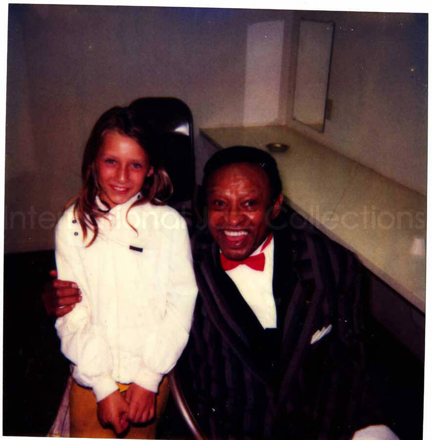 5 1/4 x 4 1/4 inch Polaroid photograph. Lionel Hampton with a girl. Handwritten on the back of the photograph: Amber Martin; San Jacinto, CA