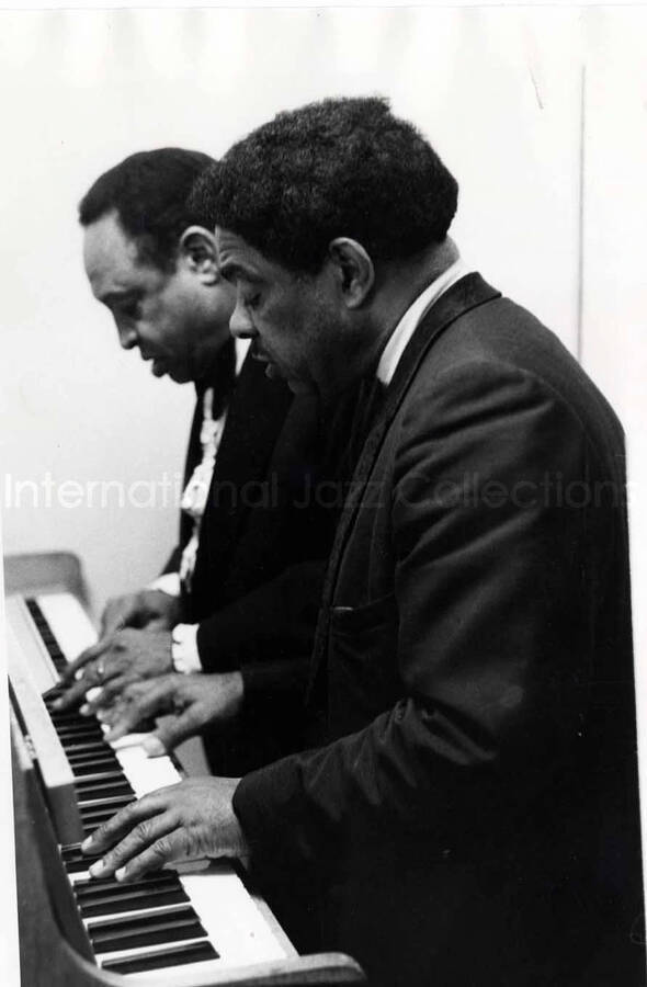 10 x 8 inch photograph. Lionel Hampton and Wild Bill Davis playing the piano