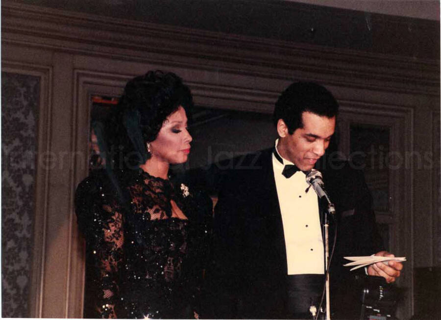 8 x 11 inch photograph. Unidentified woman and man at the Charles Hotel, Boston. From a scrapbook