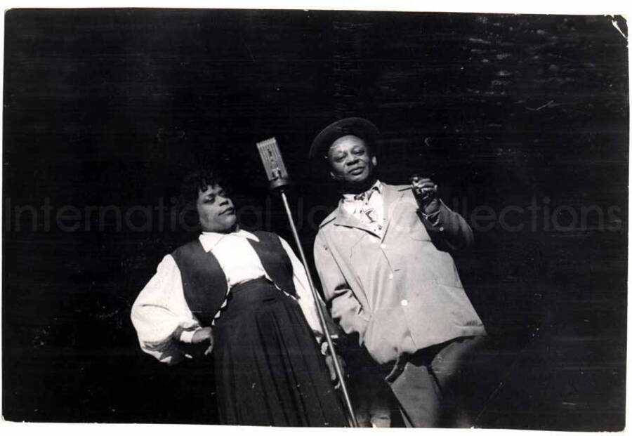 2 3/4 x 4 inch photograph. Unidentified woman and man on stage