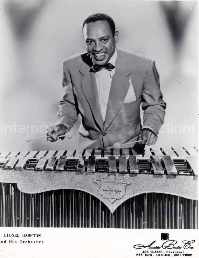 10 x 8 inch promotional photograph. Lionel Hampton playing the Deagan vibraphone. Inscription on the bottom of the photograph reads: Lionel Hampton and His Orchestra