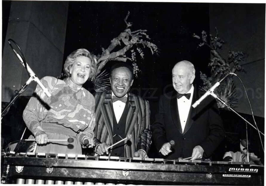 5 x 7 inch photograph. Lionel Hampton at the vibraphone with James E. Olson, Chairman of AT&T and Mrs. Jean Olson in Berkeley Heights, NJ