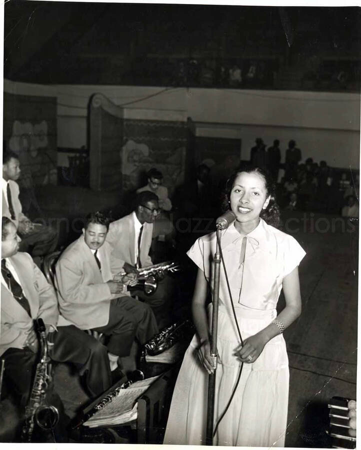 10 x 8 inch photograph. Unidentified vocalist with members of the Lionel Hampton's band