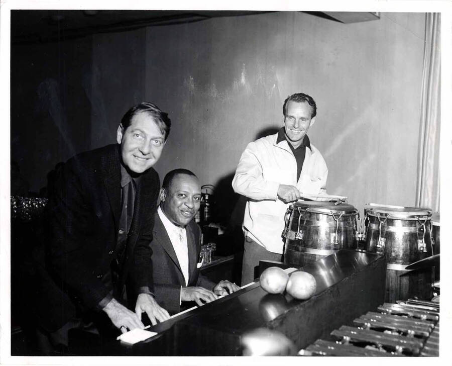 8 x 10 inch photograph. Lionel Hampton playing the piano with unidentified musicians