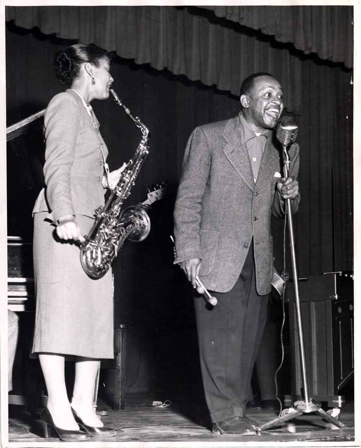 10 x 8 inch photograph. Lionel Hampton on stage with unidentified saxophonist