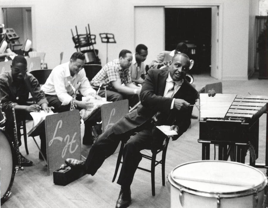 7 1 /2 x 9 1/2 inch photograph. Lionel Hampton with band. Lionel Hampton sits near the vibraphone. Bobby Plater is third from the left, Ben Kenard is fourth from the left.