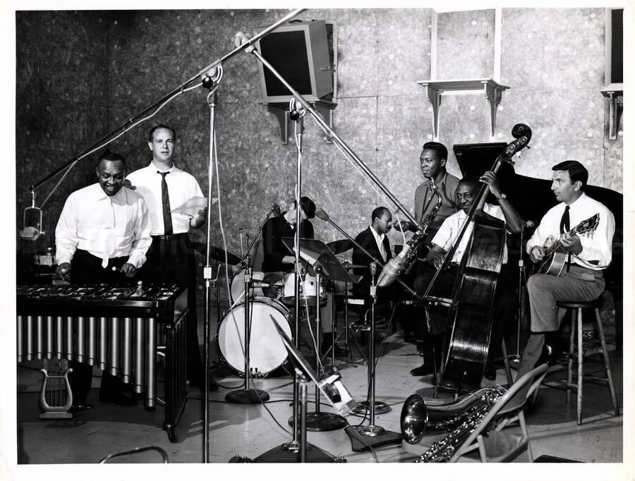 7 x 9 inch photograph. Lionel Hampton on the vibraphone with band which includes double bassist Milt Hinton