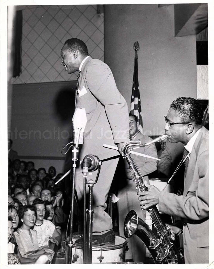 10 x 8 inch photograph. Lionel Hampton stepping on top of the drums with band
