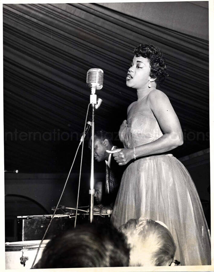 10 x 8 inch photograph. Unidentified vocalist with Lionel Hampton on vibraphone and guitarist Billy Mackel
