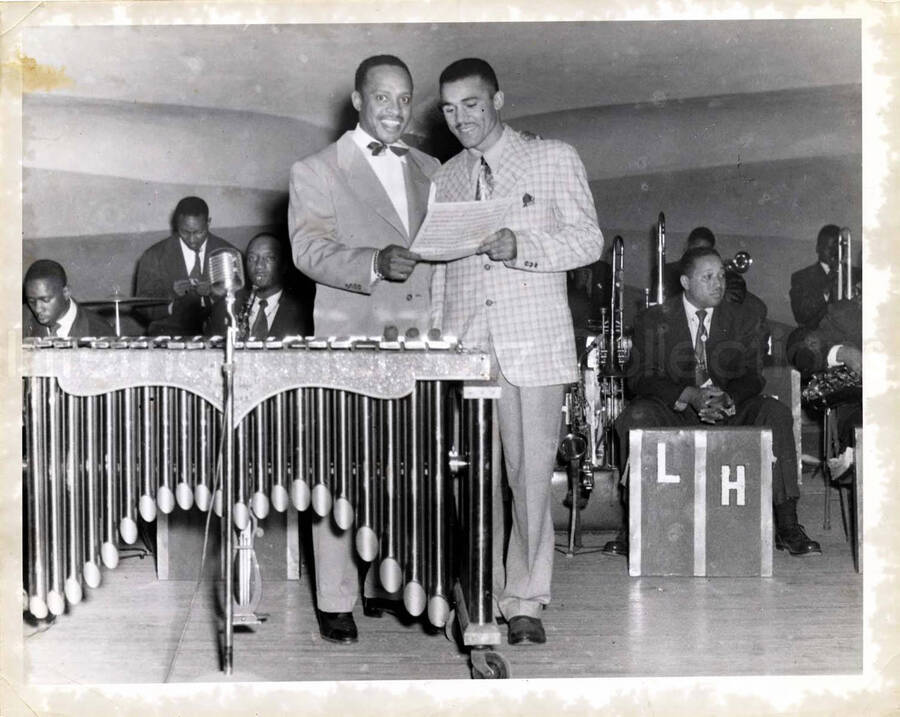 10 x 8 inch photograph. Lionel Hampton at the vibraphone with unidentified man