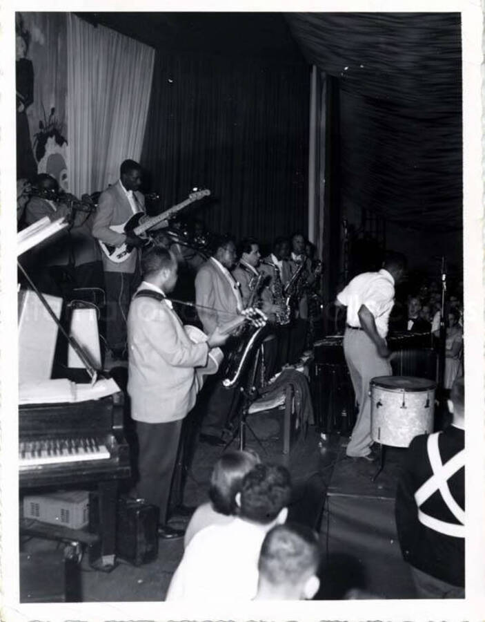 5 x 4 inch photograph. Lionel Hampton on the drums with band and young audience
