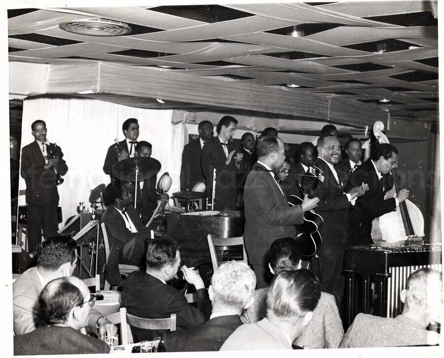 8 x 10 inch photograph. Lionel Hampton on stage with band, which includes guitarist Billy Mackel