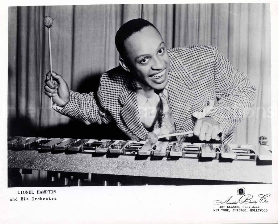 8 x 10 inch promotional photograph. Lionel Hampton playing the vibraphone. Inscription on the bottom of the photograph reads: Lionel Hampton and His Orchestra
