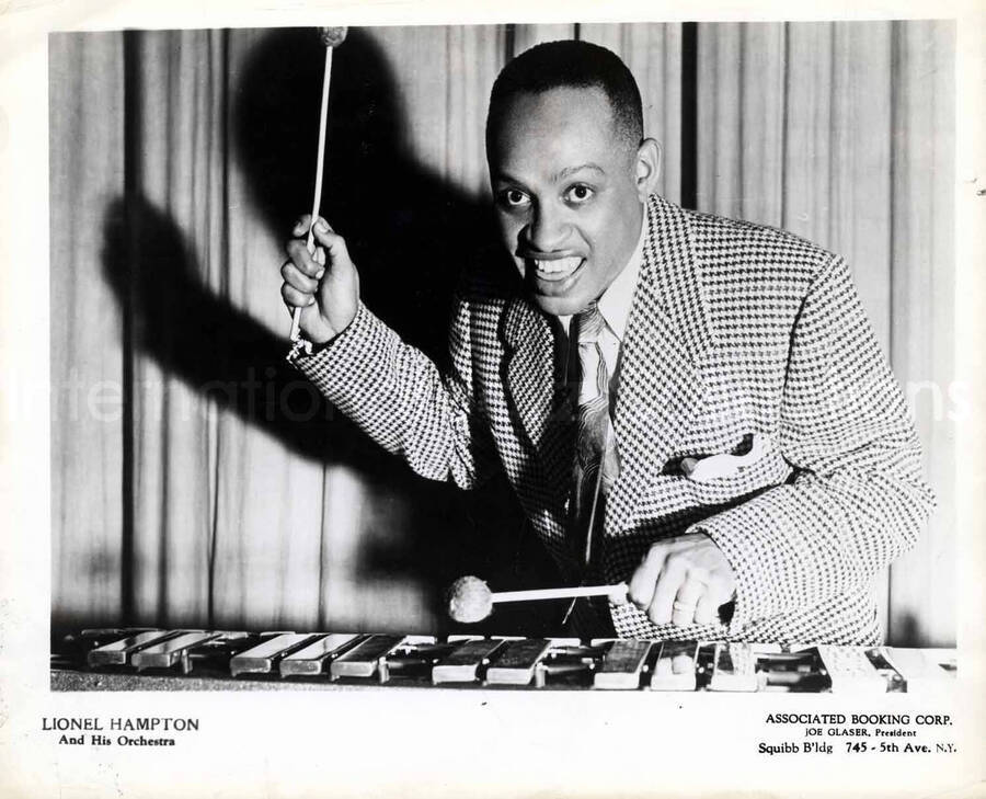 8 x 10 inch promotional photograph. Lionel Hampton playing the vibraphone. Inscription on the bottom of the photograph reads: Lionel Hampton and His Orchestra