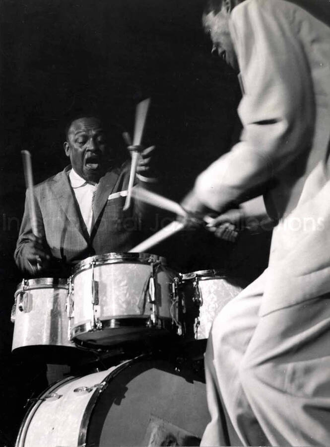9 1/2 x 7 inch photograph. Lionel Hampton and unidentified drummer playing the drums