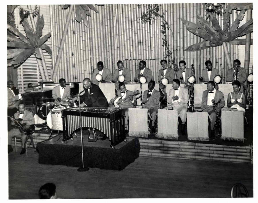 8 x 10 inch photograph. Lionel Hampton playing the vibraphone with band which includes guitarist Billy Mackel