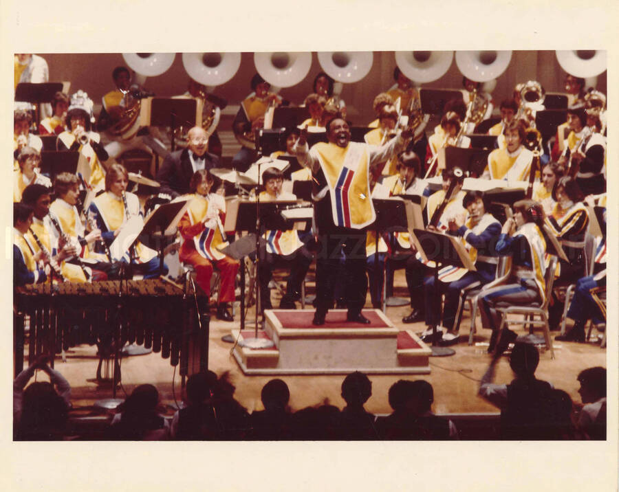 8 x 10 inch photograph. Lionel Hampton with the McDonald's All American High School Band, at Carnegie Hall in New York City. Accompanying this photograph is a letter from Frank Gihan to Lionel Hampton written on 1980-07-15.