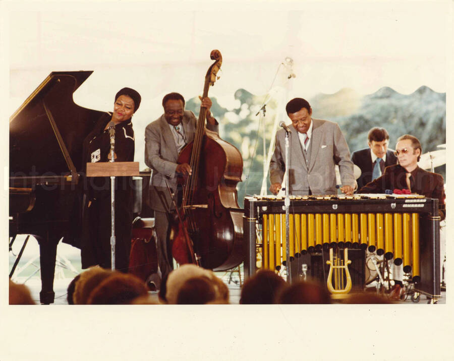 8 x 10 inch photograph. Lionel Hampton on vibraphone with Judge Milt Hinton, Pearl Bailey and other musicians at an outdoor concert at the White House. This concert was aired January 27, 1982 on the public television special, Great Vibes! Lionel Hampton and Friends, as part of the Kennedy Center Tonight series